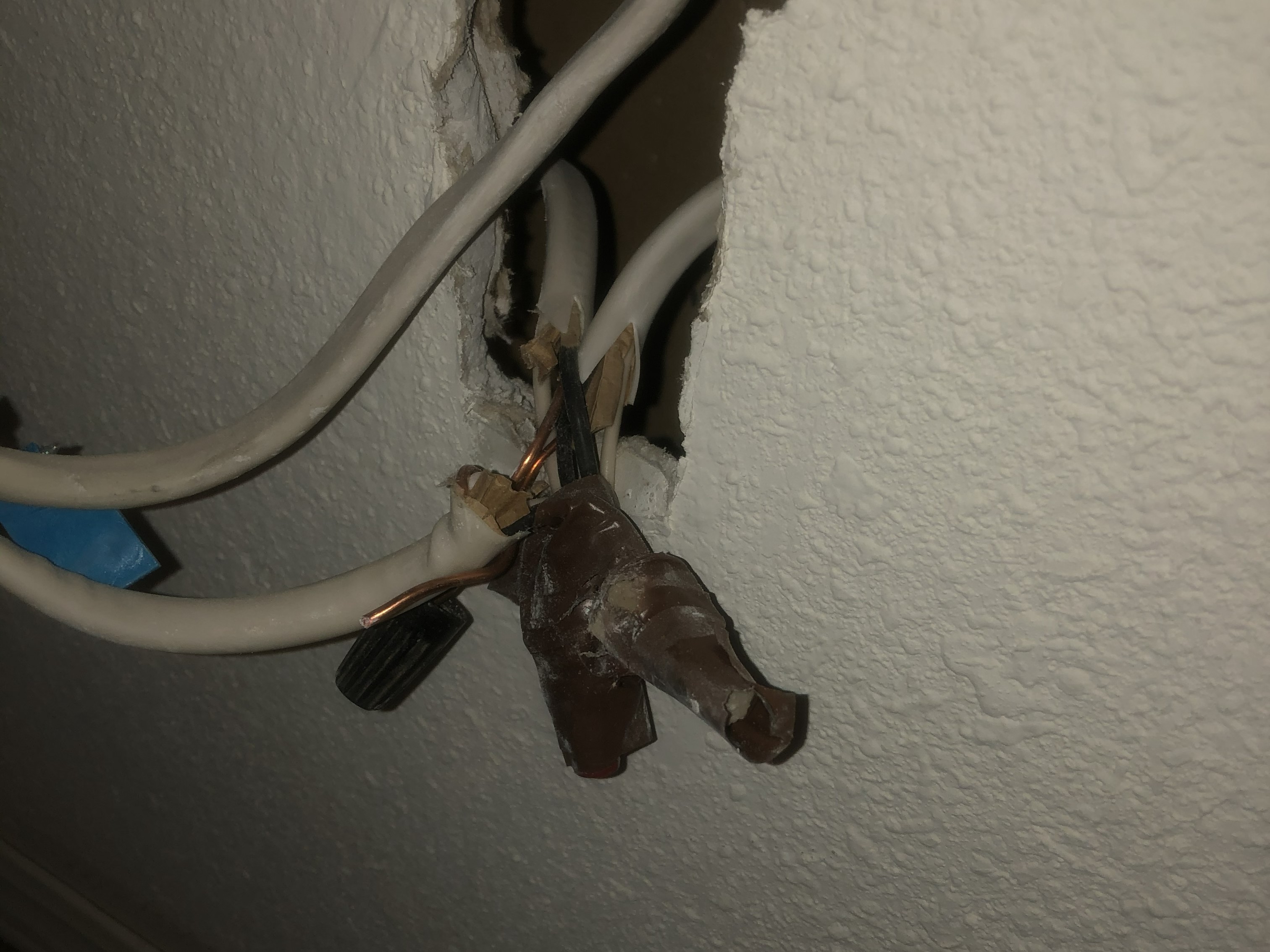 Exposed residential wiring behind a wall during electrical troubleshooting