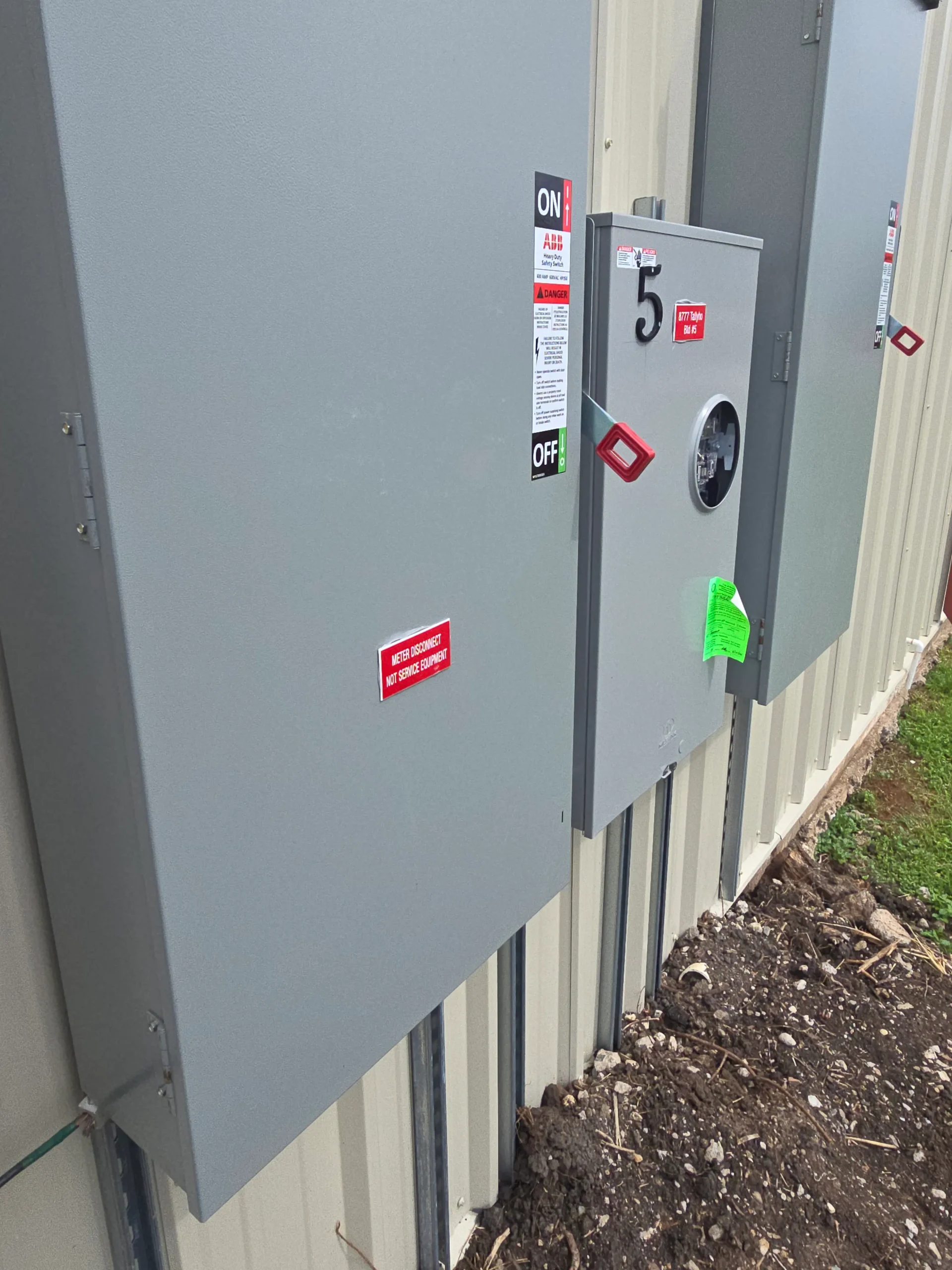 Commercial electrical service equipment with organized disconnects, meters, and conduit