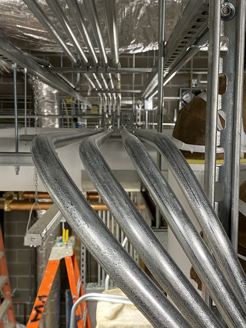 Organized commercial conduit routing with clean parallel bends and accessible layout